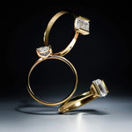 Three gold rings with lab-grown diamond accents on a dark background
