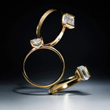 Three gold rings with lab-grown diamond accents on a dark background